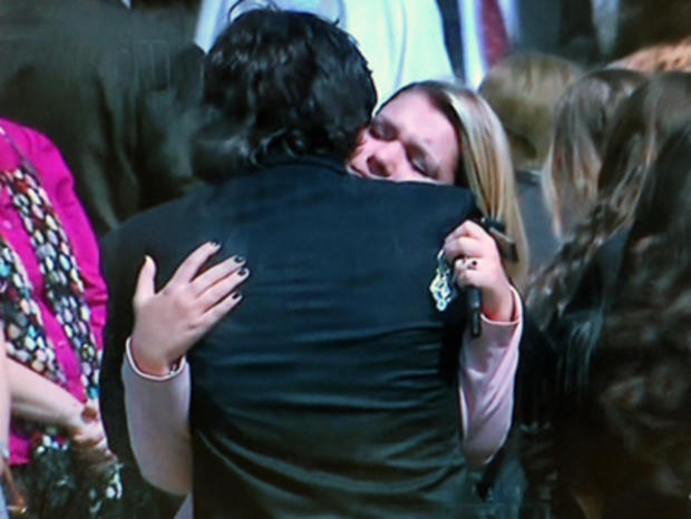 Mourners hug at Liam Anderson's funeral 