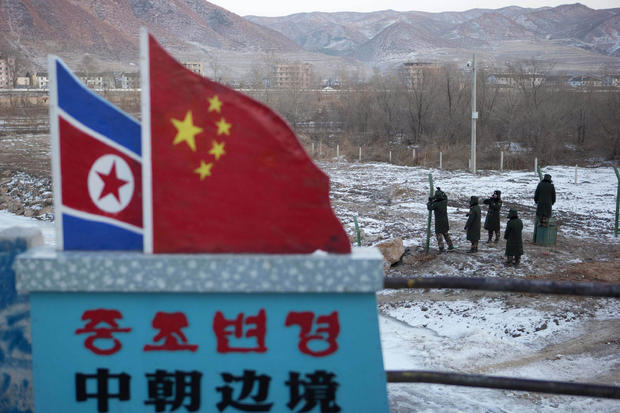 Chinese paramilitary police build a fence along the country's border withy North Korea. 