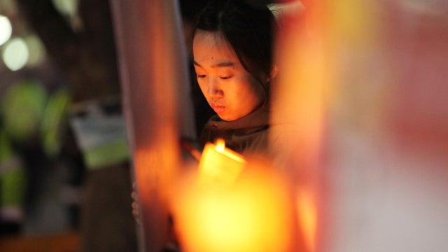 A protester holds a candle during a rally denouncing annual South Korea-U.S. joint military exercises, near the U.S. embassy in Seoul 