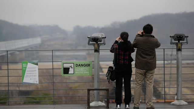 Tourists take photos of the North Korean side of the border, from the village of Panmunjom, South Korea 