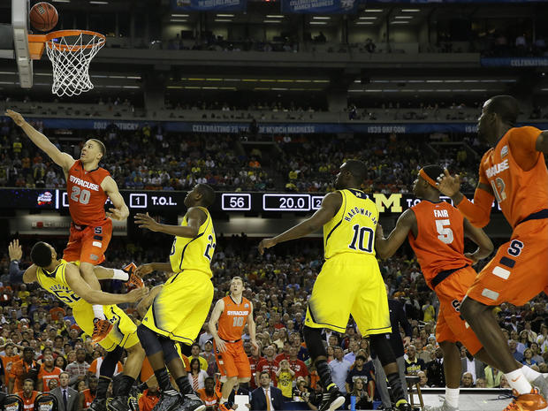 Syracuse's Brandon Triche (20) charges into Michigan's Jordan Morgan (52) during the second half of a NCAA Final Four tournament college basketball semifinal game April 6, 2013, in Atlanta. Triche was called for charging. 