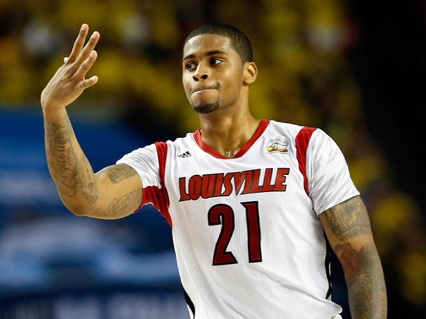 Louisville's Chane Behanan (21) holds up five fingers for injured teammate Kevin Ware (5) after the Cardinals defeat the Wichita State Shockers 72-68 during a 2013 NCAA men's Final Four semifinal at the Georgia Dome April 6, 2013, in Atlanta. 