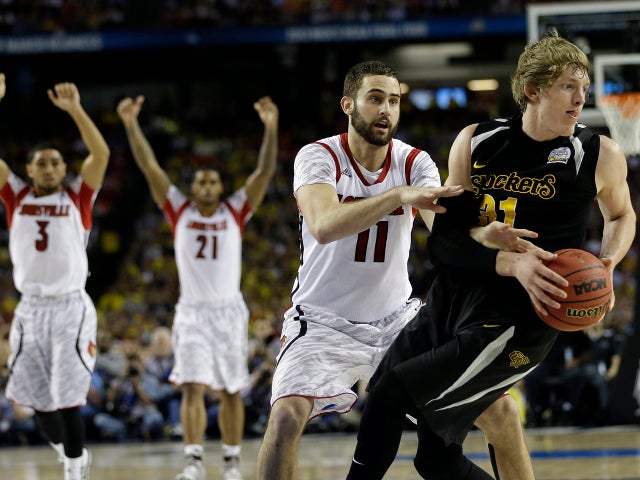 Wichita State's Ron Baker (31) and Louisville's Luke Hancock move during the second half of a NCAA Final Four tournament college basketball semifinal game April 6, 2013, in Atlanta. Louisville won 72-68. 
