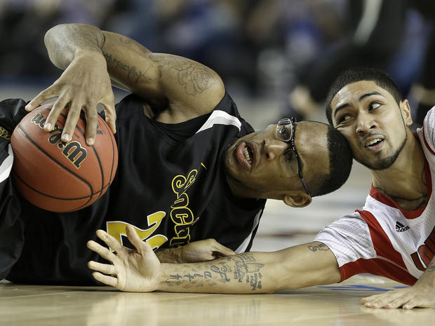 Wichita State's Carl Hall (22) and Louisville's Russ Smith (2) vie for a loose ball during the second half of a NCAA Final Four tournament college basketball semifinal game April 6, 2013, in Atlanta. 