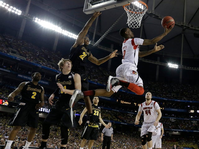 Louisville's Russ Smith (2) drives to the hoop as Wichita State's Ron Baker (31) and Wichita State's Carl Hall (22) defend during the second half of a NCAA Final Four tournament college basketball semifinal game April 6, 2013, in Atlanta. 