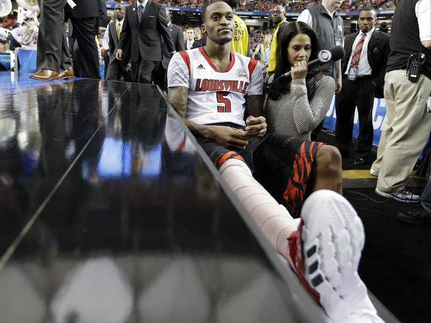 Louisville's Kevin Ware sits on the bench at the court before the first half of a NCAA Final Four tournament college basketball semifinal game against Wichita State April 6, 2013, in Atlanta. 