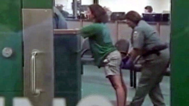 Sharyn Hakken is processed for booking into the Hillsborough County Jail early April 10, 2013, in this framegrabbed image provided by Baynews9. 