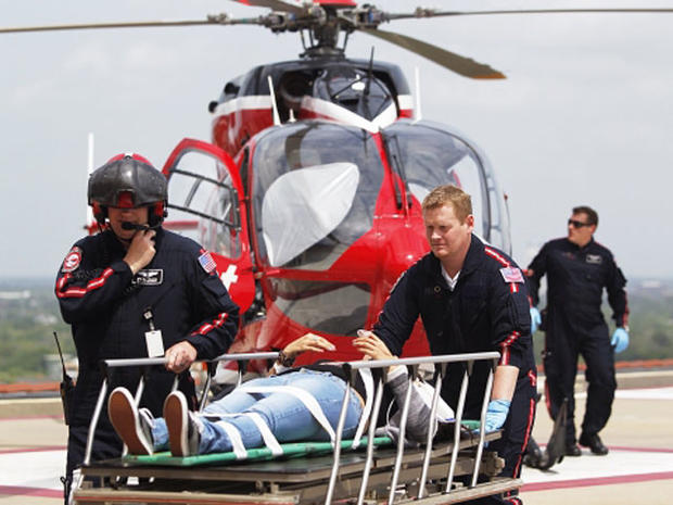 Life Flight personnel rush a victim wounded in a stabbing attack on the Lone Star community college system's Cypress, Texas campus into Memorial Hermann Hospital Tuesday, April 9, 2013 