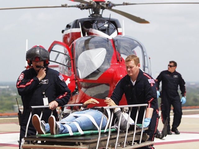 Life Flight personnel rush a victim wounded in a stabbing attack on the Lone Star community college system's Cypress, Texas campus into Memorial Hermann Hospital Tuesday, April 9, 2013 