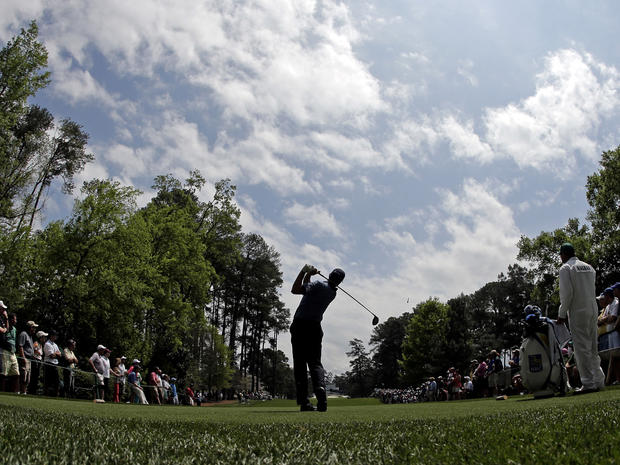 In a picture taken with a fisheye lens, Matt Kuchar tees off on the seventh hole during the second round of the Masters golf tournament April 12, 2013, in Augusta, Ga. 