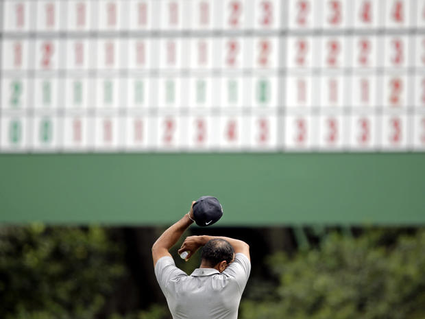 Tiger Woods wipes his forehead on the 11th green during the first round of the Masters golf tournament April 11, 2013, in Augusta, Ga. 
