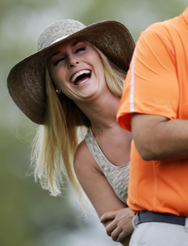 Skier Lindsey Vonn laughs while watching Tiger Woods during the first round of the Masters golf tournament April 11, 2013, in Augusta, Ga. 