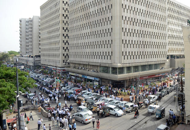 Pakistanis evacuated from buildings in Karachi following a massive earthquake centered in neighboring Iran 