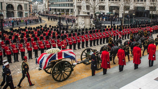 Members of the Armed Services prepare to carry Margaret Thatcher's coffin up the steps of St. Paul's Cathedral 