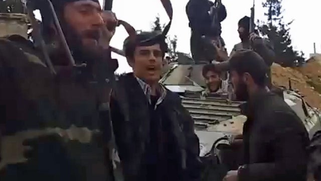 A video posted online by Syrian opposition members purportedly shows rebel fighters celebrating after seizing parts of the Dabaa military base 