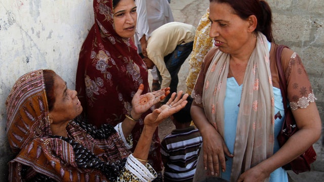Bindiya Rana, right, a transgender candidate in Pakistan's elections, talks with locals in Karachi 