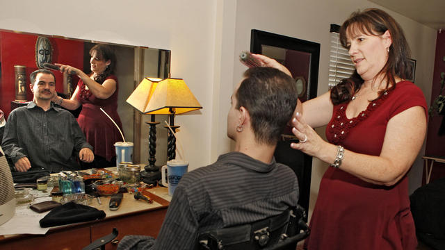 In this Dec. 6, 2012 file photo, Brandon Coats' mother Donna brushes Brandon's hair at his home in Denver. Coats, a quadriplegic medicalmarijuana patient, was fired from his job in 2010 as a telephone operator at Dish Network after testing positive for ma 