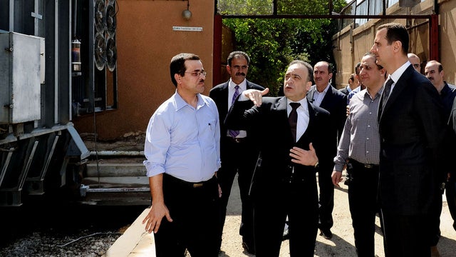President Bashar Assad, right, visits the Umayyad Electrical Station in Damascus 