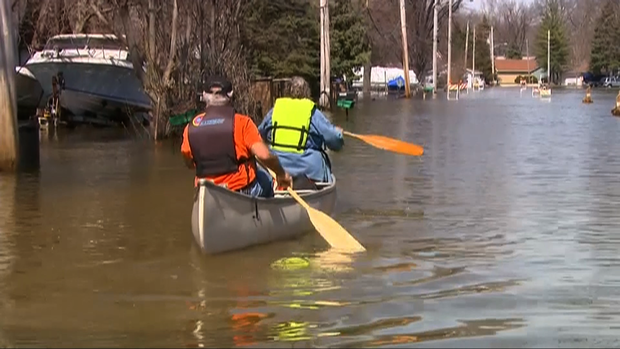 Two Fargo, N.D., residents get across the road via canoe. The Red River crested 16 feet above flood stage. 