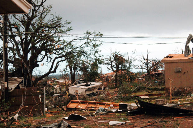 This May 16, 2013 photo provided by Nichole Tomlin shows her Granbury, Texas backyard and rubble where Tomlin says there used to be a neighborhood. A rash of tornadoes slammed into several small communities in North Texas overnight, leaving at least six p 
