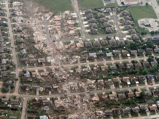 This aerial photo shows the remains of homes hit by a massive tornado in Moore, Okla