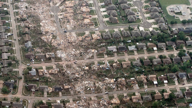 This aerial photo shows the remains of homes hit by a massive tornado in Moore, Okla 