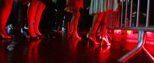 Women arrive to enter a nightclub during 