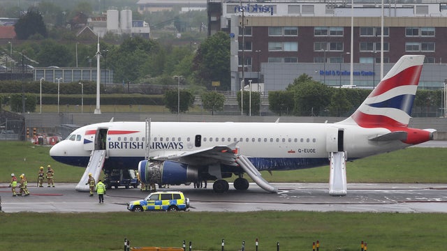 A British Airways plane surrounded by emergency vehicles 