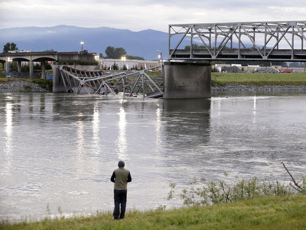 A person looks from the south bank of the Skagit River across to the collapsed portion of the Interstate 5 bridge May 24, 2013, in Mount Vernon, Wash. 