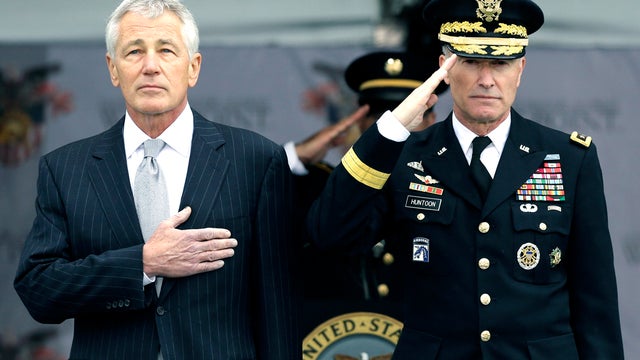Defense Secretary Chuck Hagel, left, and Superintendent Lt. Gen. David Huntoon Jr. stand for the national anthem during a graduation and commissioning ceremony at the U.S. Military Academy in West Point, N.Y., May 25, 2013. 