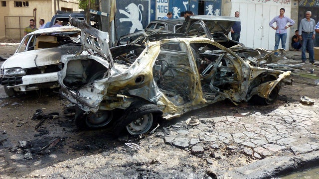 Iraqis inspect site of blast in Baghdad on May 30, 2013 