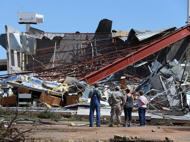 People survey the damage at the Canadian Valley Technology Center's El Reno Campus after it was hit by a powerful tornado June 1, 2013, in El Reno, Okla. 