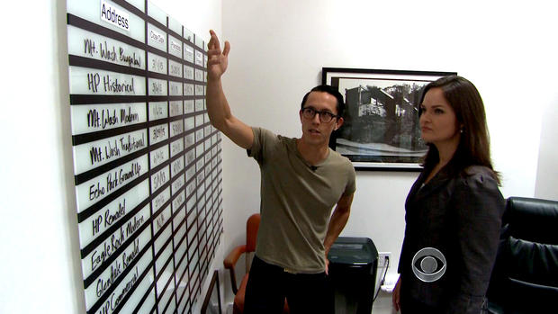 Matt Manner shows the production board in his office that lists all the homes he is flipping. 