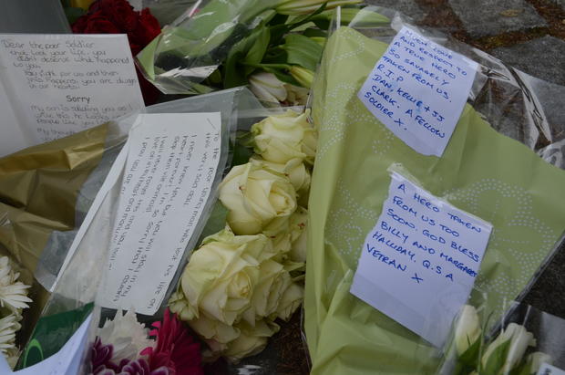 Community member leaves a flower bouquet for Drummer Lee Rigby 