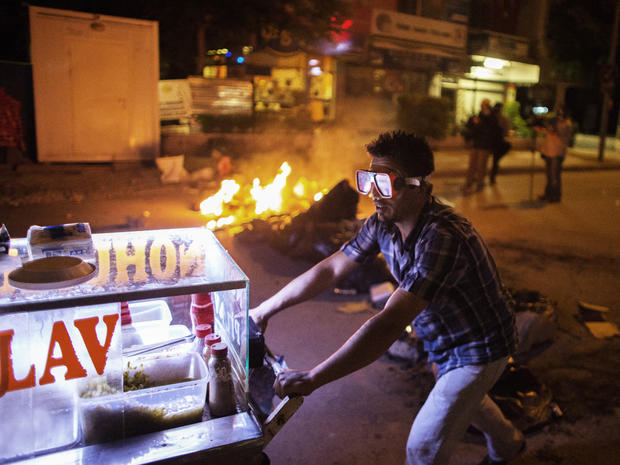 A food street vendor wears a scuba mask to protect himself from tear gas as protesters clashed with Turkish police 
