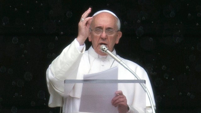 Pope Francis gives blessing during noon prayer celebrated from window overlooking St. Peter's square. 