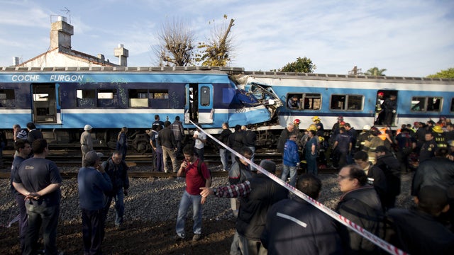 Firefighters and rescue workers respond to a fatal commuter train wreck on the outskirts of Buenos Aires, Argentina, Thursday, June 13, 2013. A two-level train slammed into another that had stopped between stations during the morning commute Thursday. 