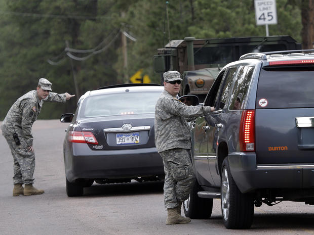 National guardsmen speak to motorists at a road block near the Black Forest Fire in Colorado Springs, Colo., on June 14, 2013. 