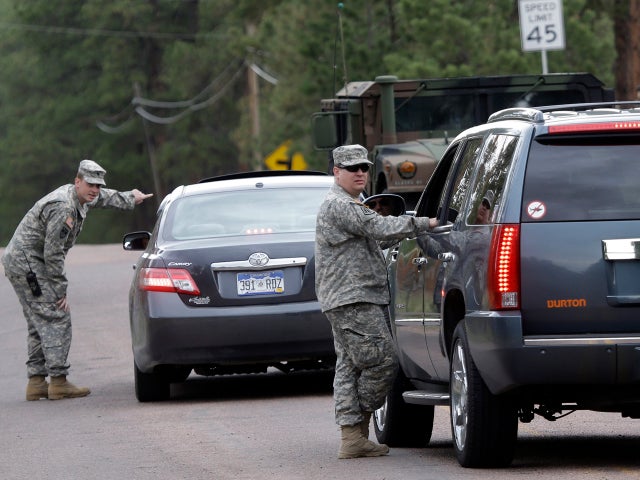 National guardsmen speak to motorists at a road block near the Black Forest Fire in Colorado Springs, Colo., on June 14, 2013. 