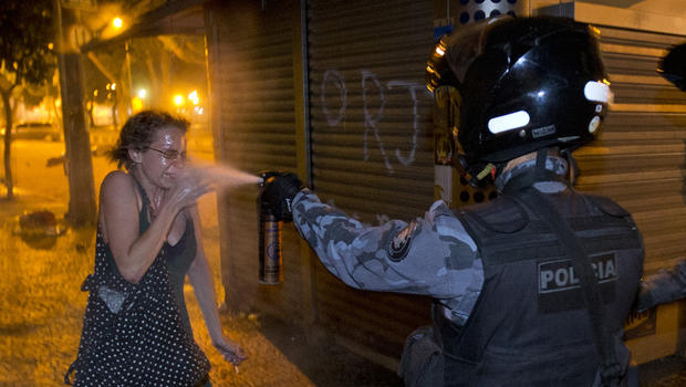 A military police peper sprays a protester during a demonstration in Rio de Janeiro, Brazil, Monday, June 17, 2013.  