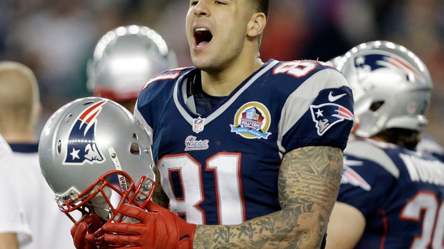 In December 2012 file photo, New England Patriots tight end Aaron Hernandez reacts during the second quarter of an NFL football game against the Houston Texans in Foxborough, Mass. State and local police spent hours at the home of New England Patriots tig 