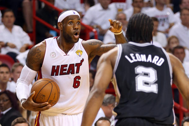 LeBron James of the Miami Heat calls a play against Kawhi Leonard of the San Antonio Spurs in the first quarter during Game 7 of the 2013 NBA Finals at AmericanAirlines Arena on June 20, 2013 in Miami, Florida.  