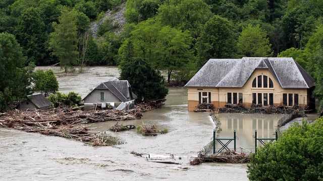 Buildings are surrounded by floodwaters near Lourdes, France, June 19, 2013. French rescue services and police evacuated hundreds of pilgrims from hotels threatened by a rain-swollen river in the Roman Catholic shrine town. 