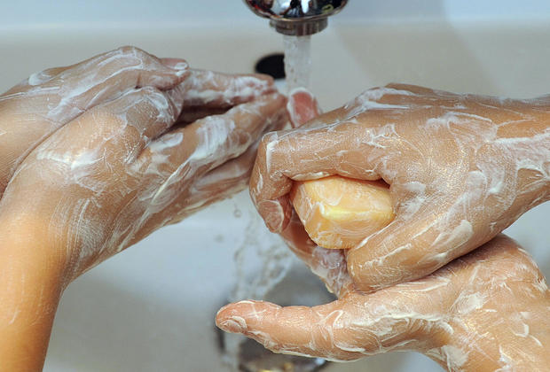 Children wash their hands with soap in t 