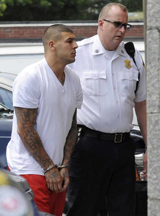 New England Patriots tight end Aaron Hernandez, left, is led into Attleboro District Court for court June 26, 2013, in Attleboro, Mass. 