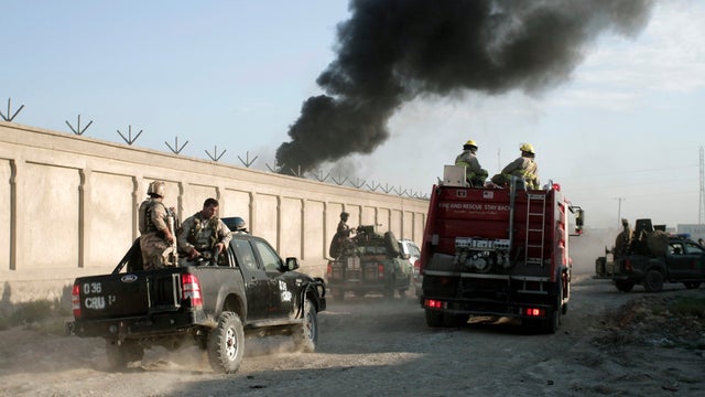 Afghan security forces near entrance gate of a NATO compound following a suicide bombing in Kabul, July 2, 2013  