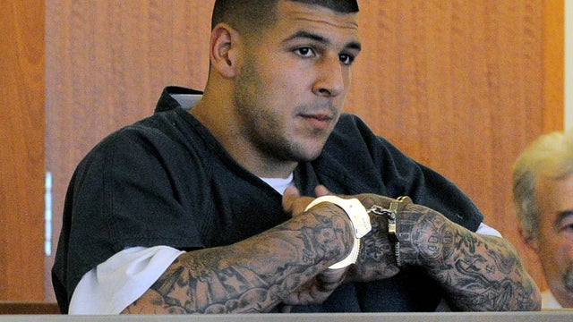 New England Patriots tight end Aaron Hernandez, left, stands with his attorney, Michael Fee, right, in Attleboro District Court June 26, 2013, in Attleboro, Mass. 