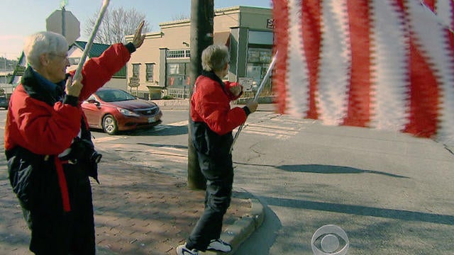 The Freeport flag ladies wave their flags every Tuesday on Main St., Freeport, Maine. 