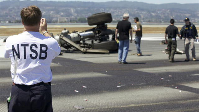 This photo released the National Transportation Safety Boards shows an NTSB officer at the scene where an Asiana Airlines flight crashed at San Francisco International Airport. 