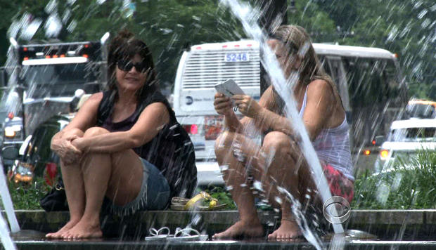 New Yorkers relax by a fountain on July 16, 2013, where temperatures reached 95 degrees. 